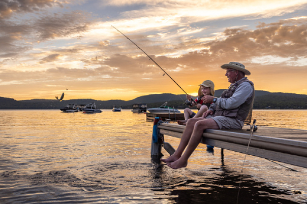 Grandparent and grandchild enjoying fishing